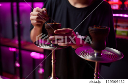 Person holding a hookah at a drinking establishment event 119306482