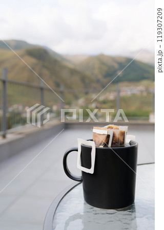 Drip coffee bag with ground coffee in cup. Making freshly coffee in mug. Drip coffee bag with ground coffee in cup. Making freshly coffee in mug. 119307209