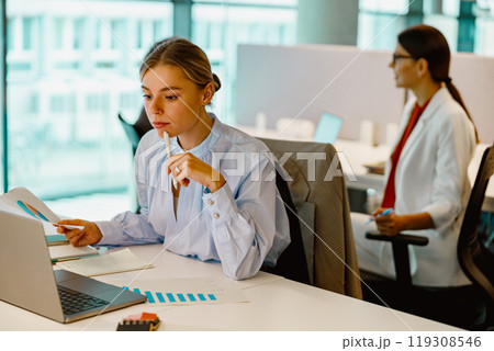 Dedicated and Focused Professionals Collaborating Effectively in a Modern Office Environment Dedicated and Focused Professionals Collaborating Effectively in a Modern Office Environment 119308546