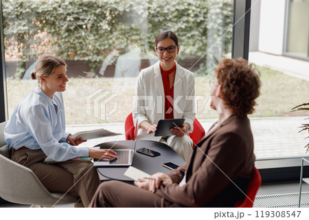 Participating in a Professional Business Meeting held within a Modern Office Space environment Participating in a Professional Business Meeting held within a Modern Office Space environment 119308547