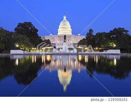 US Capitol illuminated at dusk in Washington DC with nice reflections into the water, USA 119309281