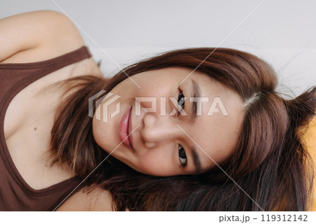 Close up of happy woman selfie herself enjoy relaxing on the sofa and pillow. Close up of happy woman selfie herself enjoy relaxing on the sofa and pillow. 119312142