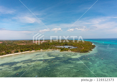 Fishing boats over turquoise sea water with corals. Tropical island with white sandy beaches. Blue sky and clouds. Bantayan Island. Cebu, Philippines. 119312373