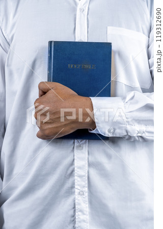 Christian man holding a holy bible in his hand. Symbol of faith in God, Christianity Feast 119312690