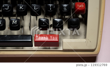 A typewriter with a red and black button that says "Thank You" on it A typewriter with a red and black button that says "Thank You" on it 119312769