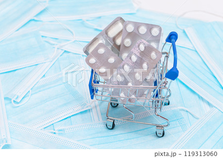 Pills and Capsules in Shopping Cart on the Surgical Masks 119313060