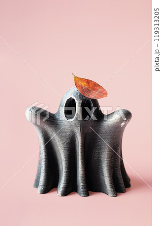 Ghost figure topped with autumn colored leaf. Artistry and seasonal themes. Ghost figure topped with autumn colored leaf. Artistry and seasonal themes. 119313205