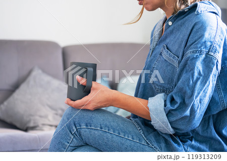 Woman enjoying coffee in cozy living room setting. Woman enjoying coffee in cozy living room setting. 119313209