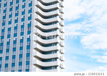 Modern apartment building featuring unique balconies. 119313211