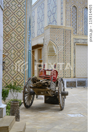 Handmade wooden cots for children on cart among decorated buildings in Samarkand, Uzbekistan Handmade wooden cots for children on cart among decorated buildings in Samarkand, Uzbekistan 119314405
