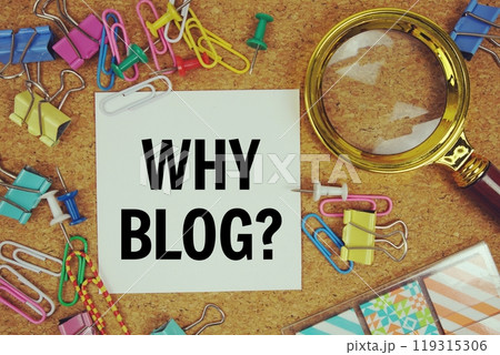 Why Blog? text on paper card with magnifying glass and stationery on cork board background Why Blog? text on paper card with magnifying glass and stationery on cork board background 119315306