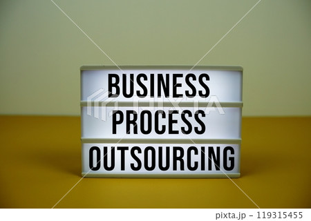 Business Process Outsourcing text on LED lightbox with alarm clock on yellow background 119315455