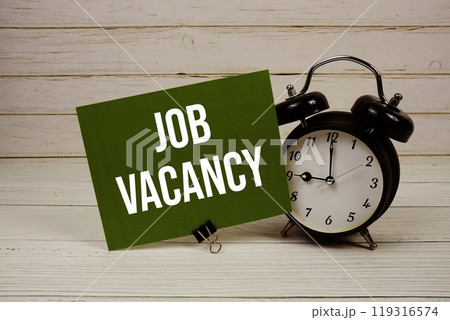 Job Vacancy text message on paper card with alarm clcok on wooden background Job Vacancy text message on paper card with alarm clcok on wooden background 119316574