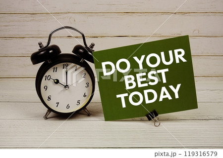 Do Your Best Today text message on paper card with alarm clcok on wooden background Do Your Best Today text message on paper card with alarm clcok on wooden background 119316579