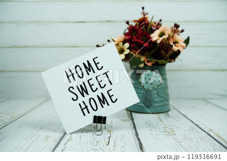 Home Sweet Home text message on paper card with flowers Home Sweet Home text message on paper card with flowers 119316691