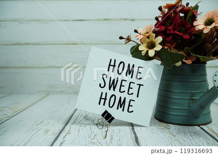Home Sweet Home text message on paper card with flowers 119316693