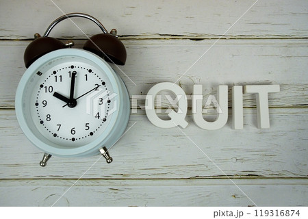 Quiz alphabet letters with alarm clock top view on wooden background Quiz alphabet letters with alarm clock top view on wooden background 119316874