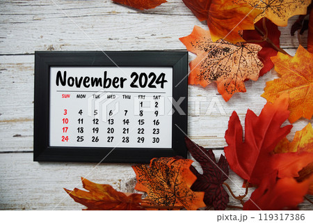 November 2024 monthly calendar maple leaf decoration on wooden background 119317386