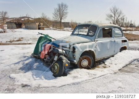 Old car in winter under the snow 119318727
