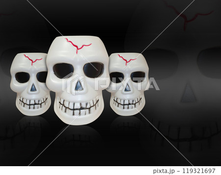 front view, three plastic skull stack on blur skull and black background, object, halloween, template, decor, copy space front view, three plastic skull stack on blur skull and black background, object, halloween, template, decor, copy space 119321697