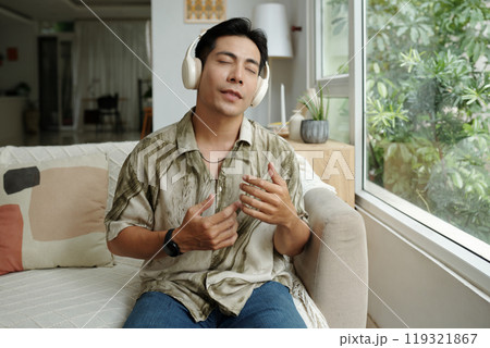 Man Enjoying Music At Home 119321867