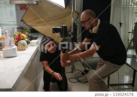 Cameraman Setting Equipment Before Shooting 119324178