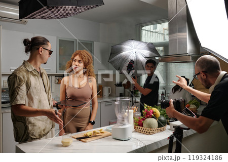 Director Telling The Script To Model 119324186