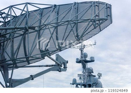 military background, naval radar antenna close up and warship in the background 119324849