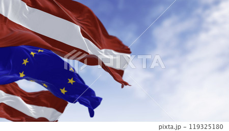 Flags of Latvia and the European Union waving on a clear day Flags of Latvia and the European Union waving on a clear day 119325180