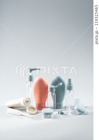 Variety of travel-sized containers displayed against a bright blue background Variety of travel-sized containers displayed against a bright blue background 119325465