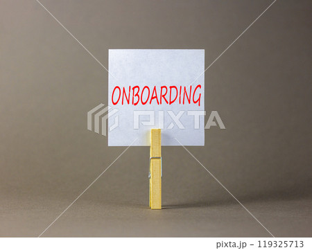 Onboarding success symbol. Concept word Onboarding on beautiful white paper on clothespin. Beautiful grey background. Business onboarding success concept. Copy space. 119325713