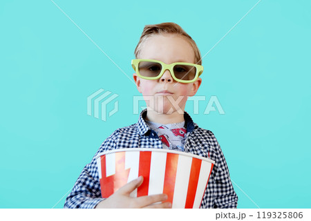 Cute fun kid baby boy 4 year old in red t-shirt holding bucket for popcorn Cute fun kid baby boy 4 year old in red t-shirt holding bucket for popcorn 119325806