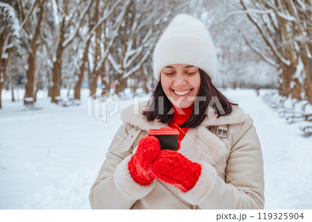 happy woman with coffee cup outdoors at winter cold day happy woman with coffee cup outdoors at winter cold day 119325904