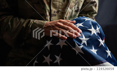 Soldier caressing the stars of a usa Flag on veterans day Soldier caressing the stars of a usa Flag on veterans day 119326059