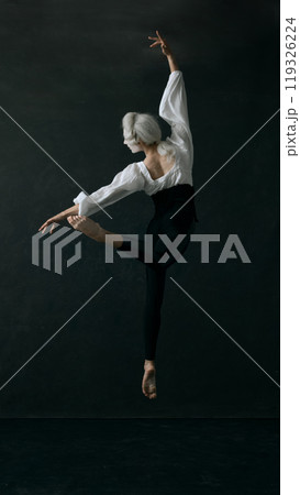 Leap frozen in time, where aristocratic grace meets fluidity of contemporary ballet. Young man dressed vintage style clothes in action. 119326224