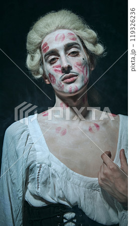 Modern aristocracy. nobleman with white powdered hair exudes confidence, kissed with bold lipstick marks, against vintage background. Modern aristocracy. nobleman with white powdered hair exudes confidence, kissed with bold lipstick marks, against vintage background. 119326236