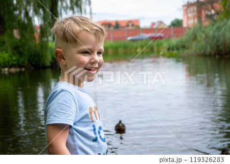 Small boy playing on a pond 119326283