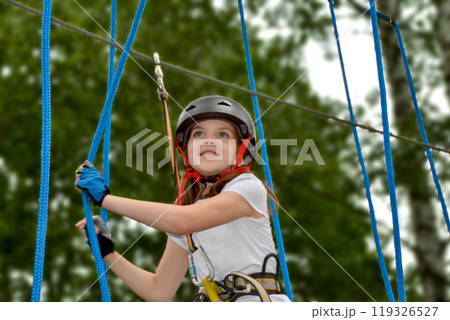 adventure climbing high wire park - people on course in mountain helmet adventure climbing high wire park - people on course in mountain helmet 119326527