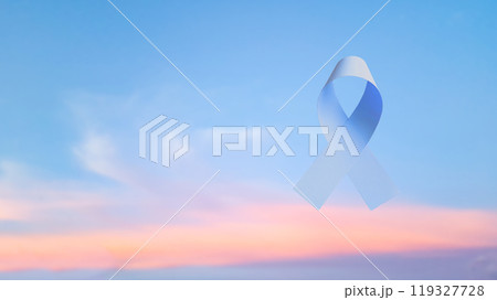 Hand holding blue ribbon, symbolizing prostrate cancer awareness. Ribbon represents hope and unity, raising awareness and support for those affected by cancer, fostering understanding and prevention. 119327728