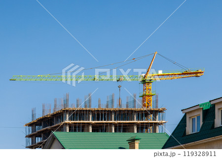 An Urban Construction Site Featuring a Large Crane and an Emerging New Building Structure An Urban Construction Site Featuring a Large Crane and an Emerging New Building Structure 119328911