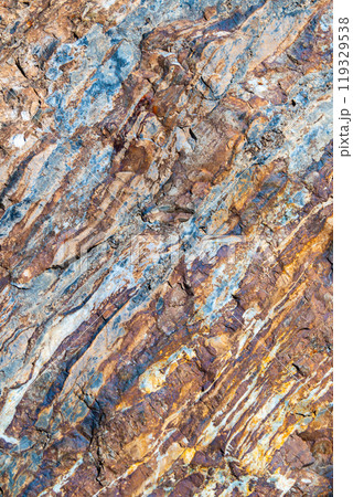 The texture of granite stone with a texture resembling marble, in dark brown tones. The surface of the stone is replete with interesting patterns and inclusions, creating an effect of depth and natura The texture of granite stone with a texture resembling marble, in dark brown tones. The surface of the stone is replete with interesting patterns and inclusions, creating an effect of depth and natura 119329538