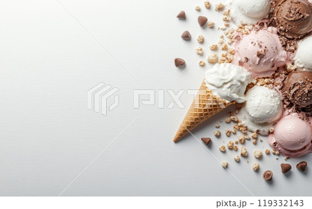 Various scoops of colorful ice cream with chocolate chips, waffle cone, and crumbs on white background. Dessert and indulgence concept with copy space 119332143