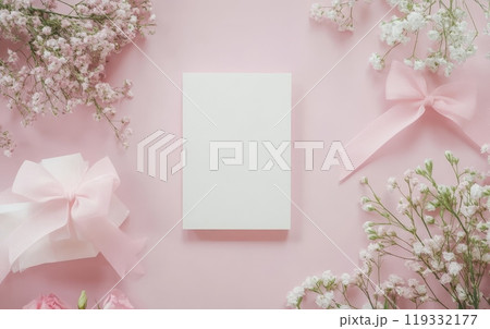 Elegant white and pink flowers frame a blank card on a soft pink background with ribbon bows, perfect for wedding, birthday, or feminine designs 119332177