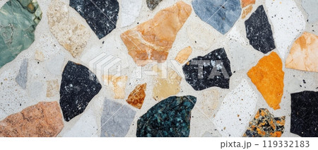 Close up of vibrant terrazzo texture with multicolored stone fragments embedded in concrete, creating a modern and artistic surface pattern 119332183