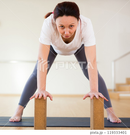 Pregnant woman is engaged in yoga. Standing Half Forward Bend or Ardha Uttanasana 119333401