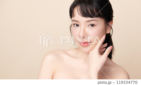 Beautiful young asian woman with clean fresh skin on beige background, Face care, Facial treatment, Cosmetology, beauty and spa, Asian women portrait. Beautiful young asian woman with clean fresh skin on beige background, Face care, Facial treatment, Cosmetology, beauty and spa, Asian women portrait. 119334770
