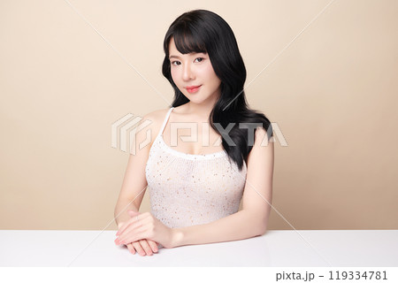 Beautiful young asian woman with clean fresh skin on beige background, Face care, Facial treatment, Cosmetology, beauty and spa, Asian women portrait. 119334781