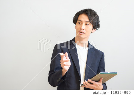 タブレットを持って話をする男性 119334990