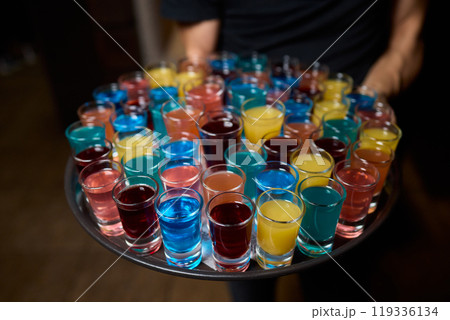 Vibrant and Colorful Shot Glasses Arranged on a Tray for a Fun and Lively Party Event Vibrant and Colorful Shot Glasses Arranged on a Tray for a Fun and Lively Party Event 119336134