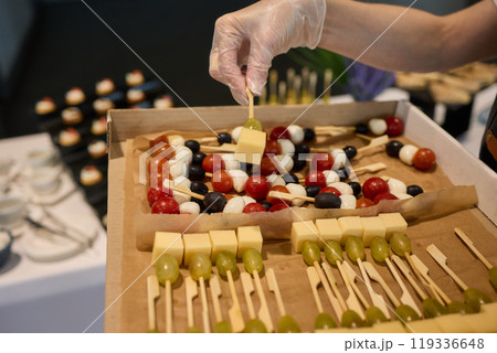 A Vibrantly Colorful Appetizer Platter Featuring Skewers and a Variety of Fresh Ingredients 119336648